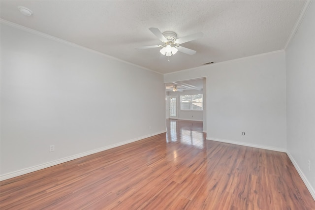 spare room featuring ornamental molding, hardwood / wood-style floors, a textured ceiling, and ceiling fan