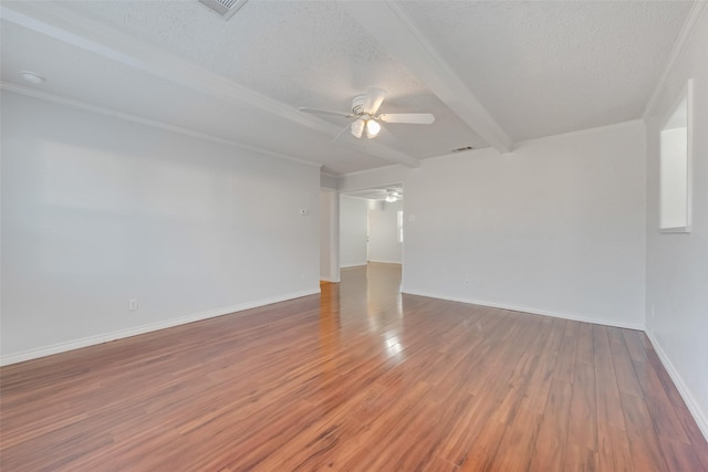 unfurnished room with beamed ceiling, ceiling fan, a textured ceiling, and hardwood / wood-style flooring