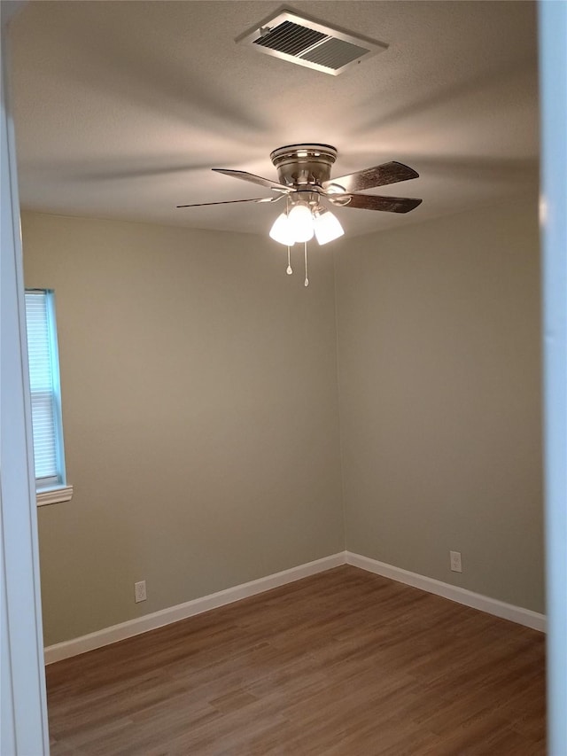 spare room with dark hardwood / wood-style floors and ceiling fan