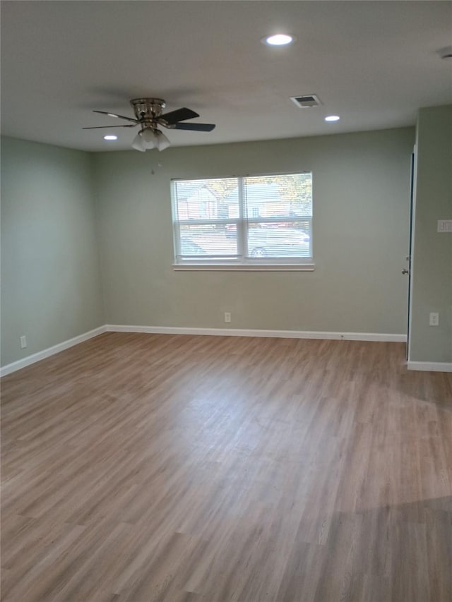 empty room with ceiling fan and light wood-type flooring