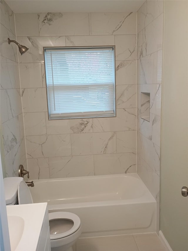 full bathroom with tile patterned floors, vanity, toilet, and tiled shower / bath combo