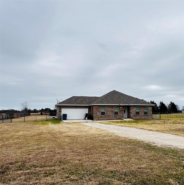 ranch-style house featuring a garage and a front yard