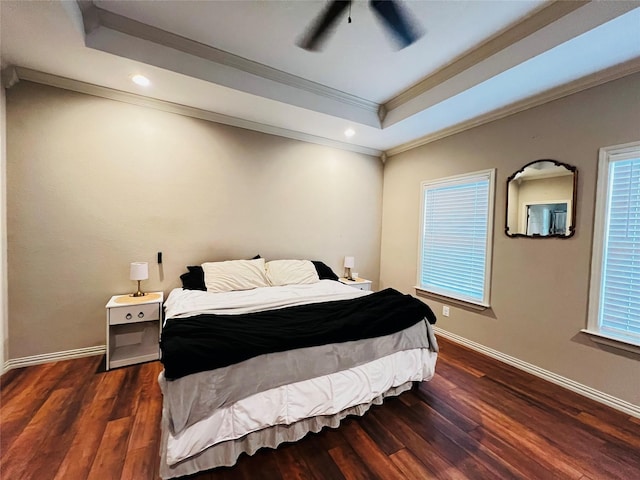 bedroom featuring ornamental molding, wood finished floors, a raised ceiling, and baseboards