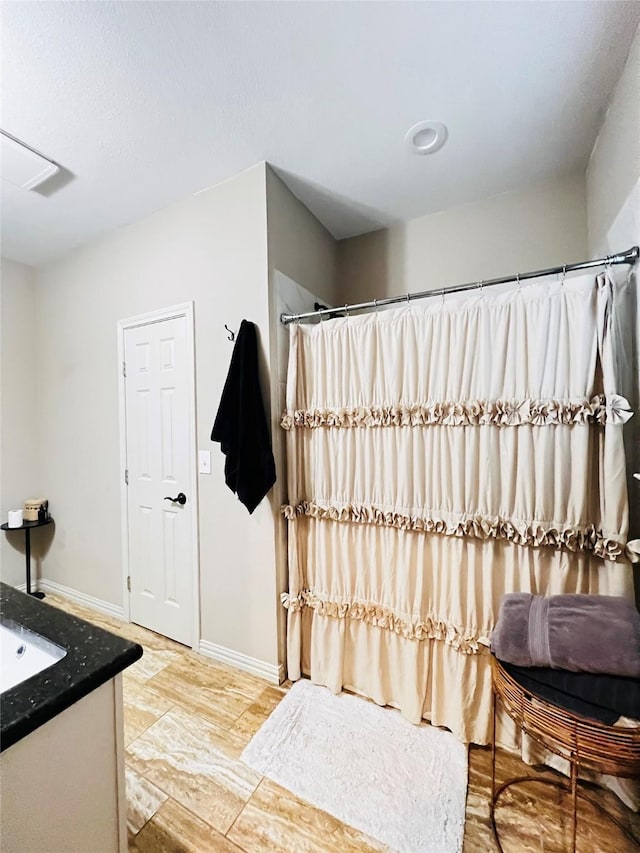 full bathroom featuring vanity, baseboards, and a shower with shower curtain