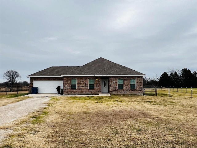 ranch-style house featuring a garage and a front yard