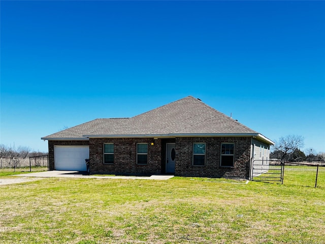 ranch-style house featuring an attached garage, brick siding, fence, driveway, and a front yard