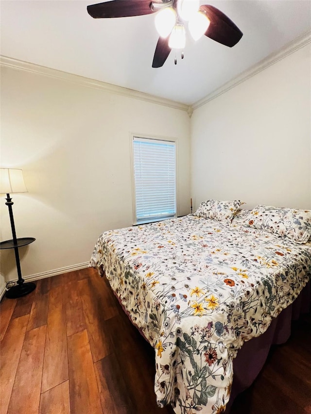 bedroom featuring a ceiling fan, crown molding, baseboards, and hardwood / wood-style flooring