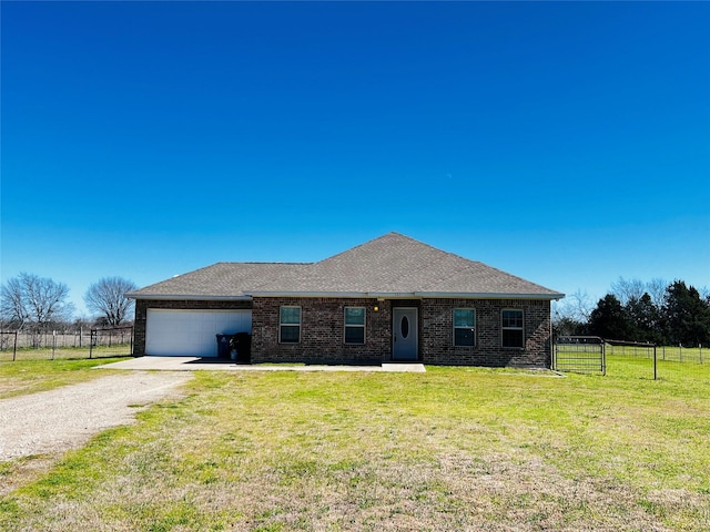 single story home featuring an attached garage, gravel driveway, fence, a front lawn, and brick siding