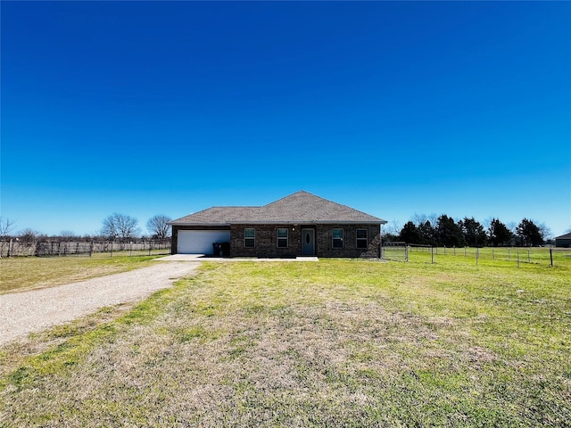 view of front of home featuring a garage, brick siding, fence, driveway, and a front lawn