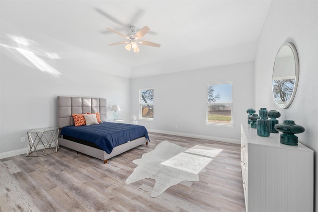 bedroom with light hardwood / wood-style floors and ceiling fan