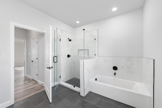 bathroom with tile patterned floors and shower with separate bathtub