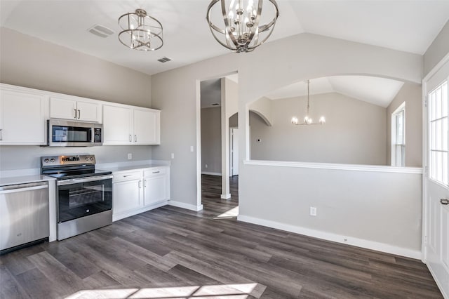 kitchen featuring pendant lighting, white cabinets, appliances with stainless steel finishes, and a notable chandelier