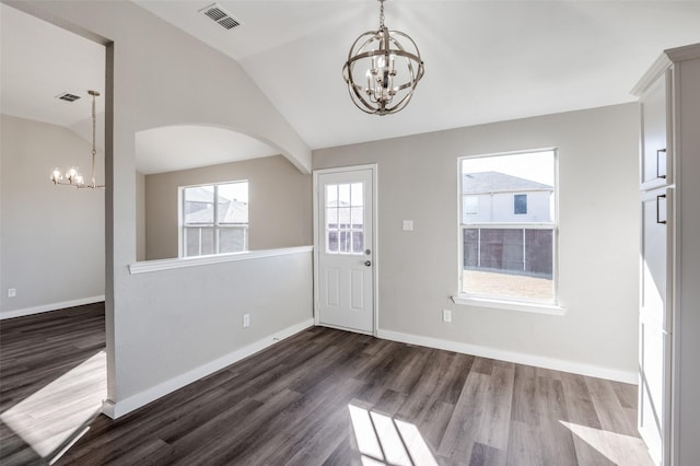 foyer entrance featuring an inviting chandelier, dark hardwood / wood-style floors, and vaulted ceiling