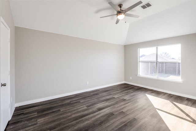 empty room featuring lofted ceiling, dark wood-type flooring, and ceiling fan