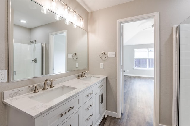 bathroom featuring vanity, an enclosed shower, and wood-type flooring