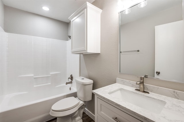 full bathroom featuring vanity, washtub / shower combination, and toilet