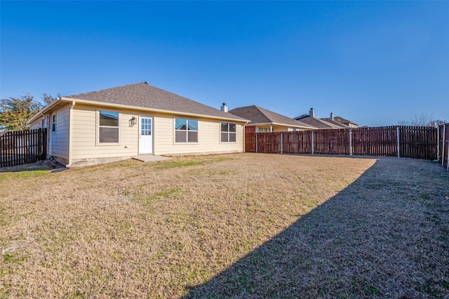 back of property with a lawn