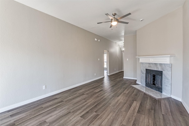 unfurnished living room with dark hardwood / wood-style floors, ceiling fan, and a premium fireplace