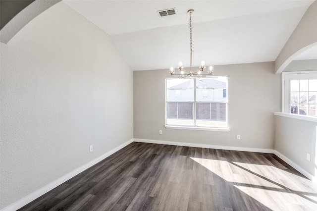 unfurnished dining area featuring vaulted ceiling, an inviting chandelier, and dark hardwood / wood-style flooring