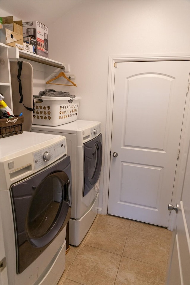 laundry area featuring light tile patterned flooring and separate washer and dryer