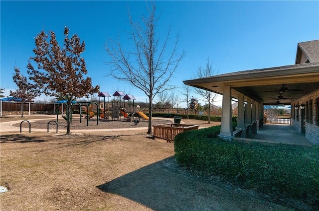 view of yard with ceiling fan and a playground