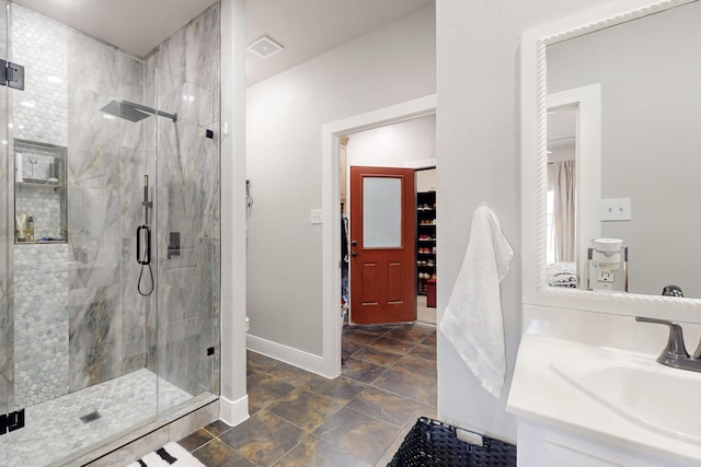 bathroom with visible vents, baseboards, toilet, vanity, and a shower stall