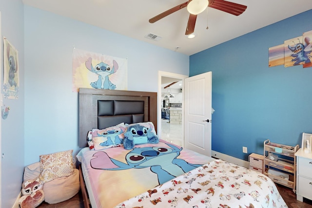 bedroom with a ceiling fan, visible vents, and baseboards