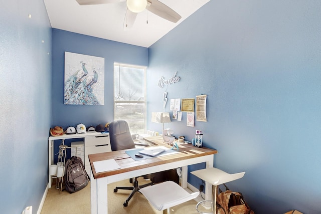 home office with baseboards, a ceiling fan, and light colored carpet