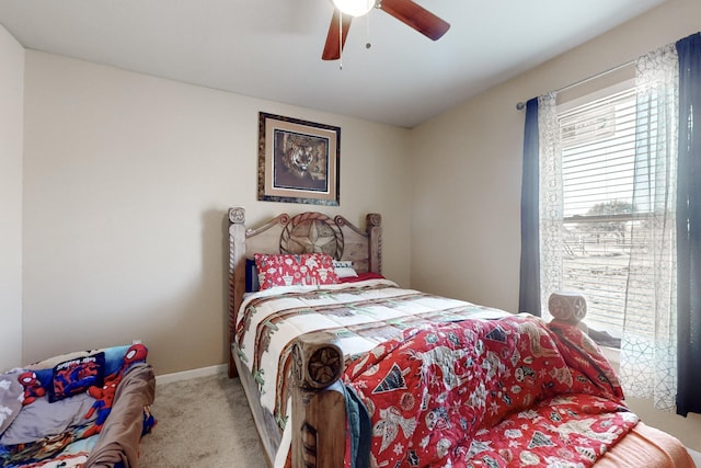 bedroom with baseboards, a ceiling fan, and light colored carpet