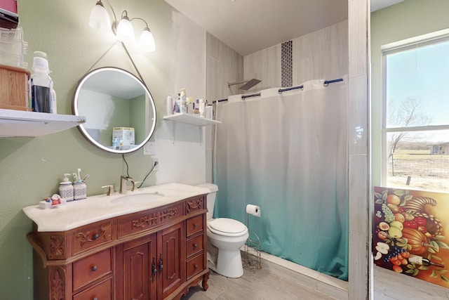 full bath with toilet, a shower with shower curtain, vanity, and a healthy amount of sunlight