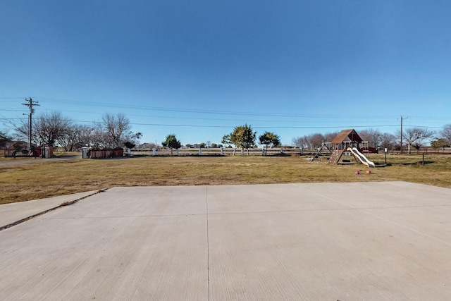 view of yard featuring a playground and fence