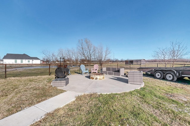 view of yard featuring a patio area, fence, and a fire pit