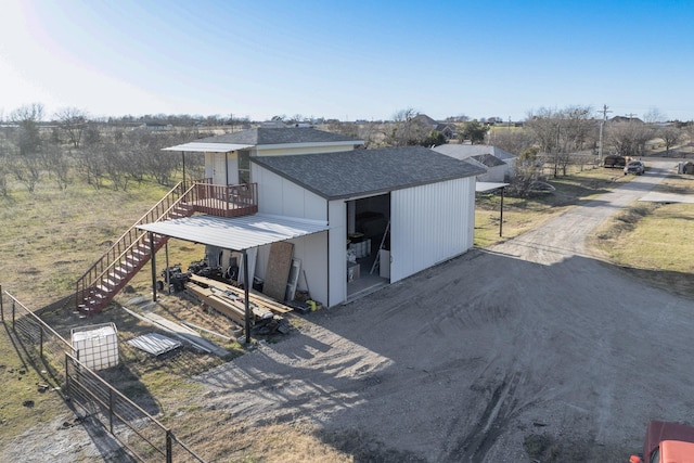 exterior space featuring fence and stairs