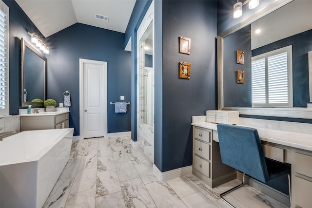 bathroom featuring lofted ceiling, vanity, and a washtub