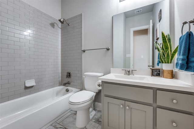 full bathroom with vanity, tiled shower / bath combo, and toilet