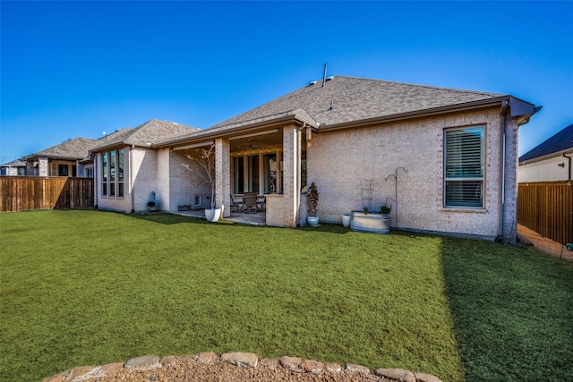 back of property featuring a yard and a patio area