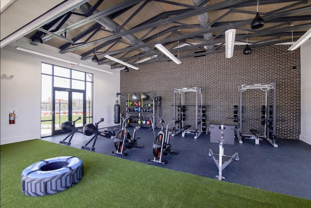 workout area featuring high vaulted ceiling