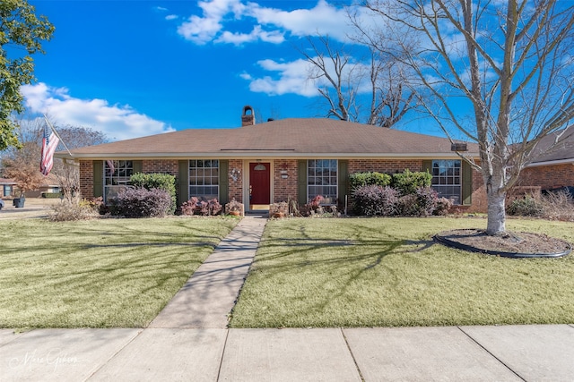 ranch-style home with a front lawn