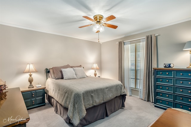 carpeted bedroom with ornamental molding and ceiling fan