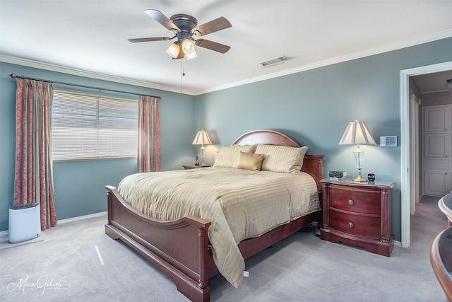 bedroom featuring ornamental molding, light colored carpet, and ceiling fan