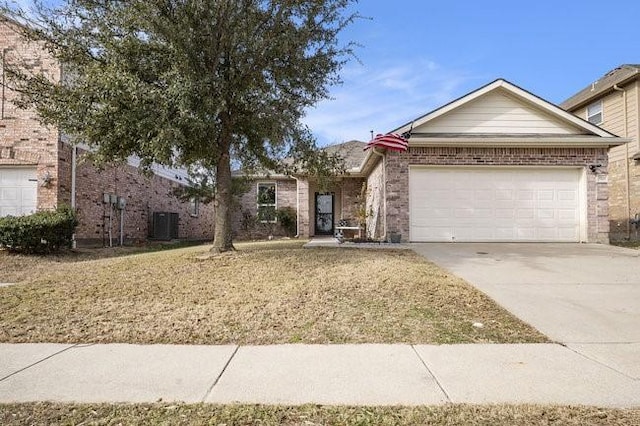 view of front of house with a garage and central AC