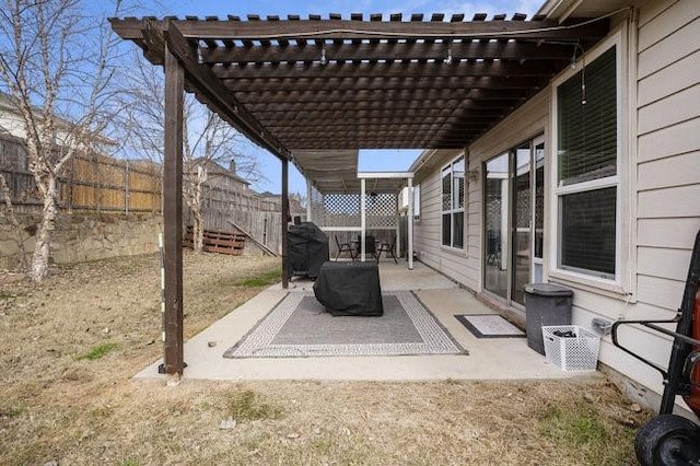 view of patio with area for grilling and a pergola