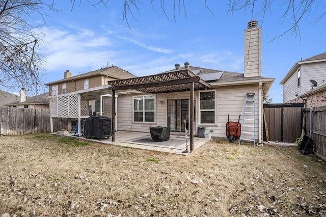 back of house with a yard and a patio