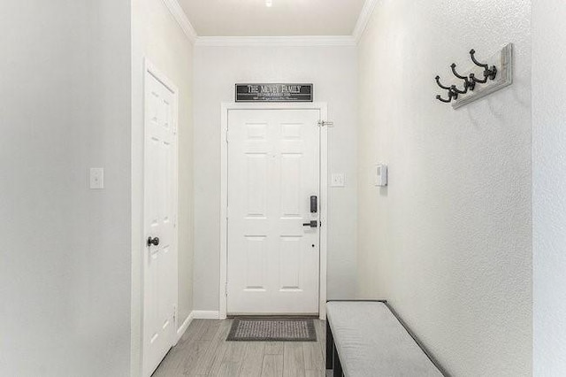 doorway to outside with crown molding and hardwood / wood-style floors