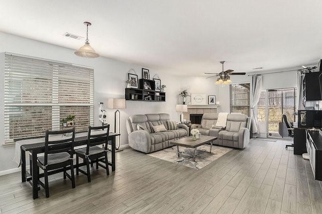 living room with hardwood / wood-style floors and ceiling fan