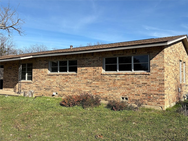 view of side of home featuring a yard