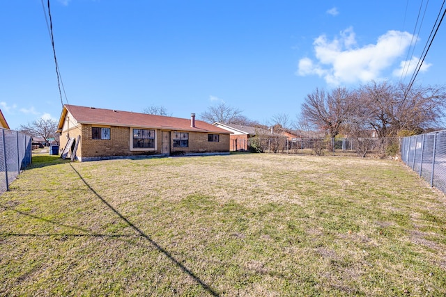 rear view of property featuring a yard