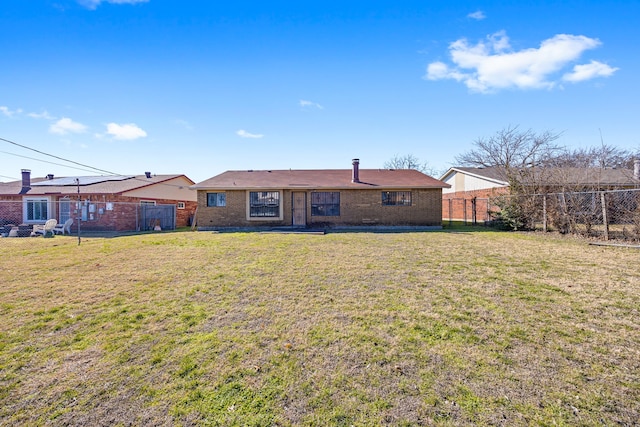 rear view of property with a yard