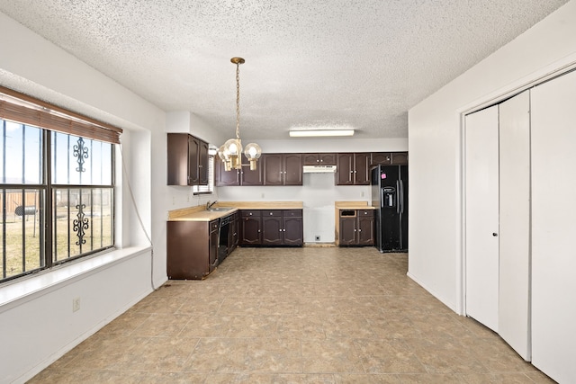 kitchen with decorative light fixtures, sink, black appliances, dark brown cabinets, and an inviting chandelier