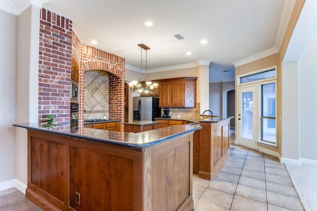 kitchen featuring pendant lighting, backsplash, ornamental molding, kitchen peninsula, and stainless steel refrigerator with ice dispenser